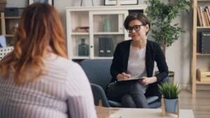 Persona recibiendo terapia psicológica en un entorno acogedor, simbolizando el bienestar emocional y el apoyo profesional.