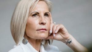 Mujer de mediana edad en proceso de sanación emocional durante la menopausia tras experiencias de trauma infantil.