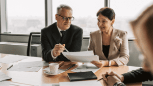 Profesional ofreciendo asesoría fiscal a autónomo en despacho empresarial.