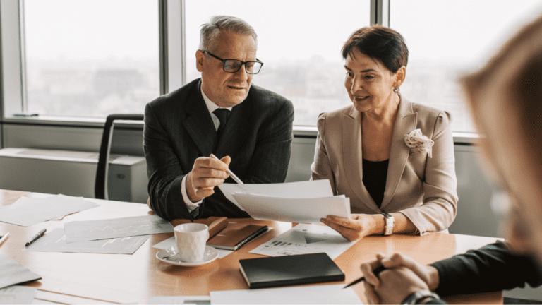 Profesional ofreciendo asesoría fiscal a autónomo en despacho empresarial.