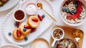 Brunch vegetariano y desayuno saludable con café, pancakes y frutas en cafetería de Barcelona